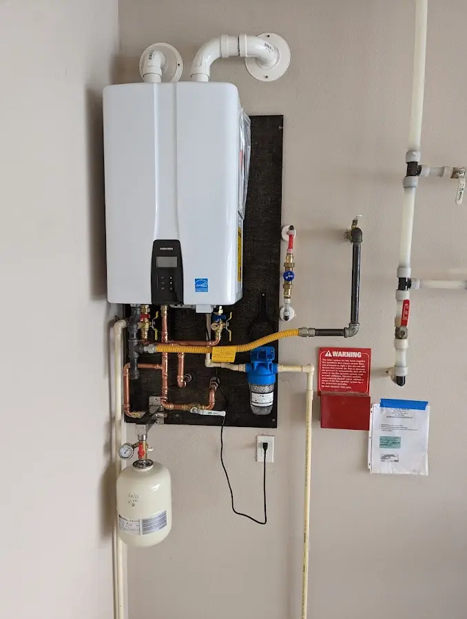 Professional plumber installing copper piping in a Micco home